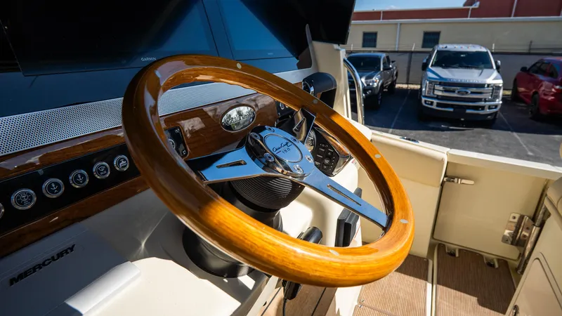 Slide: The Image of 2025 Chris-Craft Catalina 30 steering wheel, featuring elegant wood and chrome design. - 28