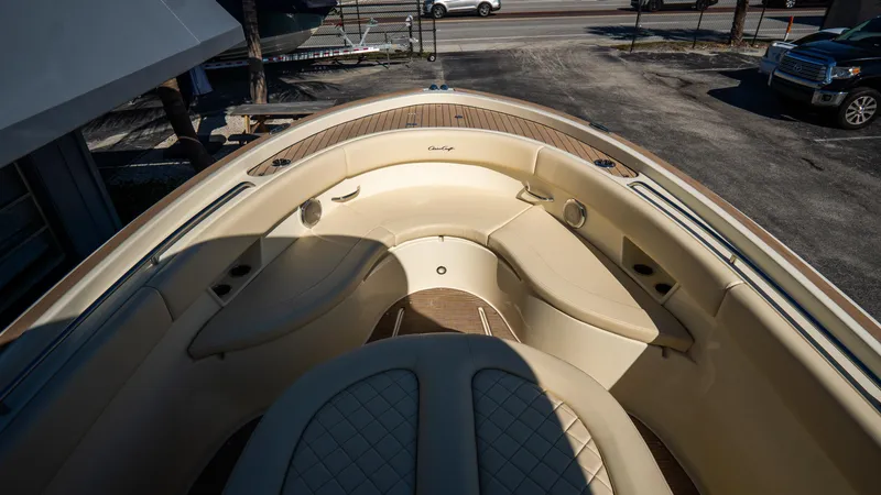 Slide: The Image of 2025 Chris-Craft Catalina 30 boat interior with beige seating and wood accents. - 35