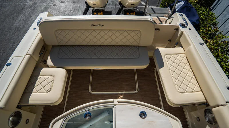 Slide: The Image of 2025 Chris-Craft Catalina 30 boat interior with beige seating and wood flooring. - 8