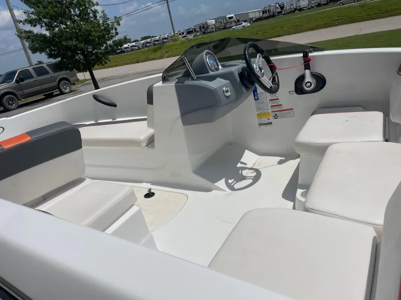 Slide: The Image of 2020 Tahoe T16 boat interior with white seating and steering wheel. - 10