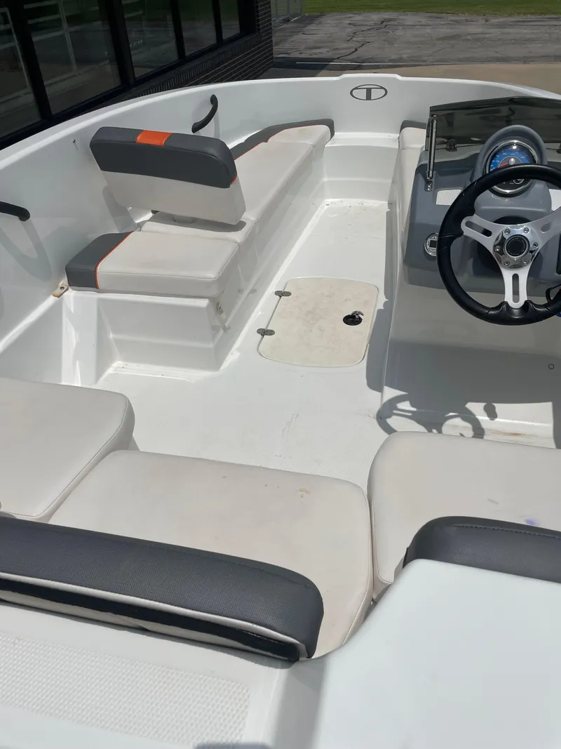Slide: The Image of 2020 Tahoe T16 boat interior with seating and steering wheel, showcasing modern design. - 8