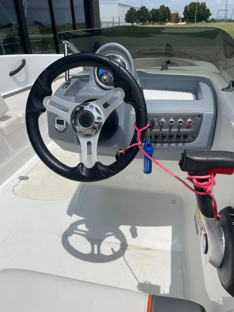 Slide: The Image of Steering wheel and dashboard of a 2020 Tahoe T16 boat, featuring control panel and throttle. - 9