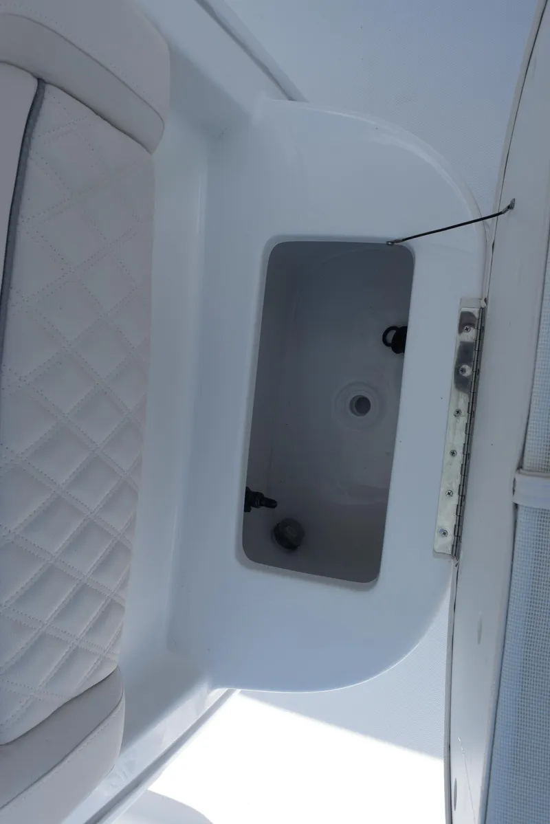 Slide: The Image of 2026 Sea Hunt BX 25 FS boat interior storage compartment with quilted seating detail. - 16