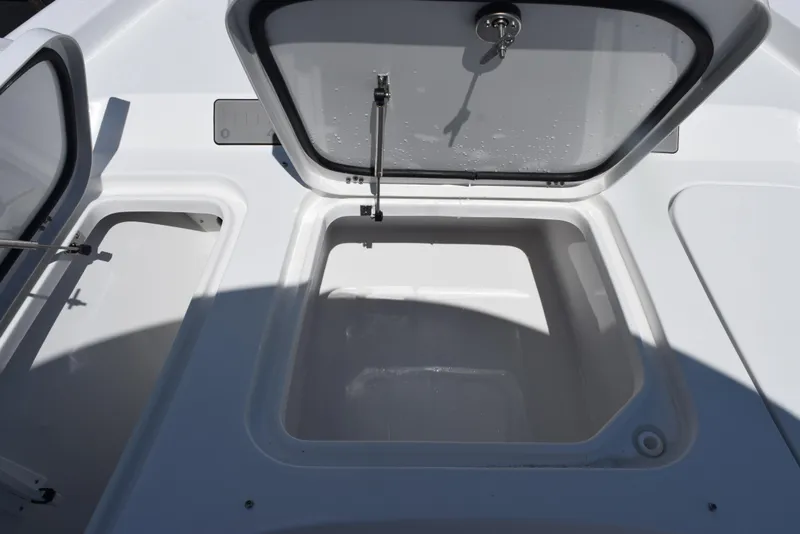 Slide: The Image of Open storage compartments on a 2026 Sea Hunt BX 25 FS boat. - 18