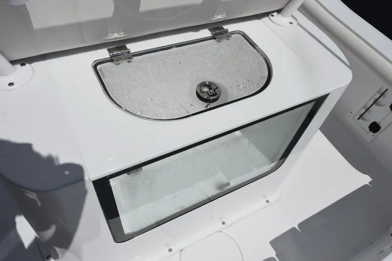 Slide: The Image of 2026 Sea Hunt BX 25 FS boat livewell with transparent lid and secure latch. - 22