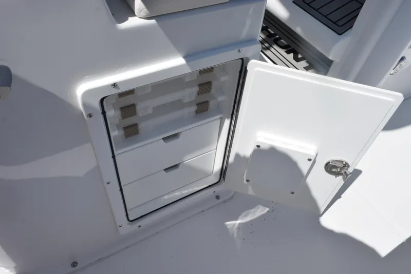 Slide: The Image of Open storage compartment on 2026 Sea Hunt BX 25 FS boat. - 23