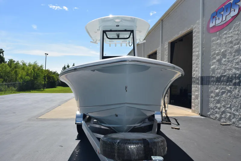 Slide: The Image of 2026 Sea Hunt BX 25 FS boat on trailer outside a building under clear sky. - 3