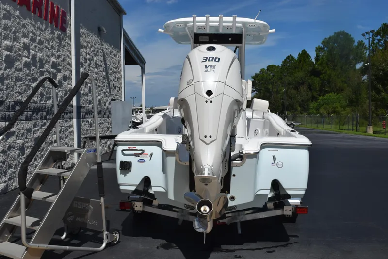 Slide: The Image of 2026 Sea Hunt BX 25 FS boat with powerful outboard motor, parked near a marine facility. - 5