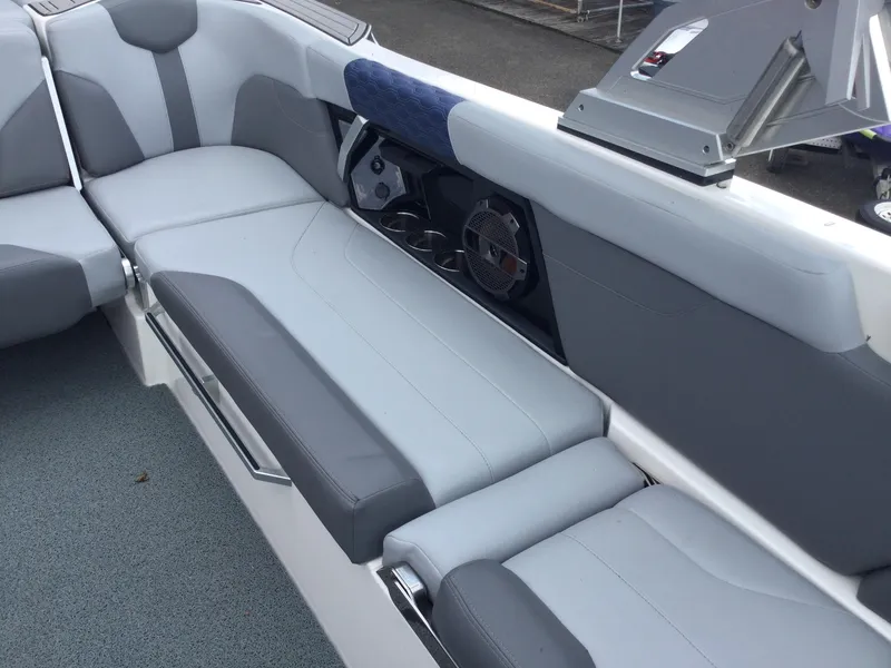 Slide: The Image of 2022 MasterCraft XT24 boat interior with gray seating and speaker system. - 17