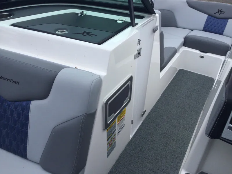 Slide: The Image of 2022 MasterCraft XT24 boat interior with gray and blue seating. - 20