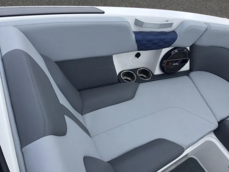 Slide: The Image of 2022 MasterCraft XT24 boat interior with gray seating and cup holders. - 23