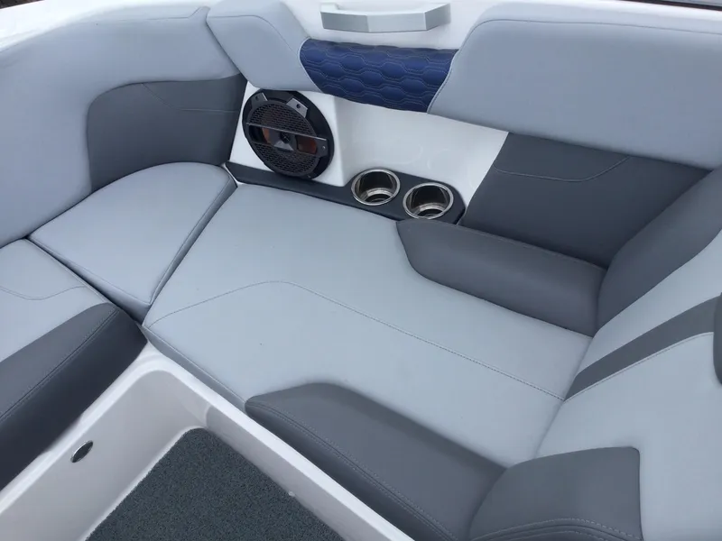 Slide: The Image of 2022 MasterCraft XT24 boat interior with gray seating and built-in speakers. - 25