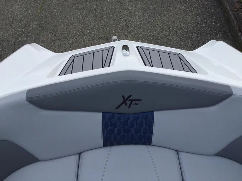 Slide: The Image of 2022 MasterCraft XT24 boat interior with gray and blue seating. - 27