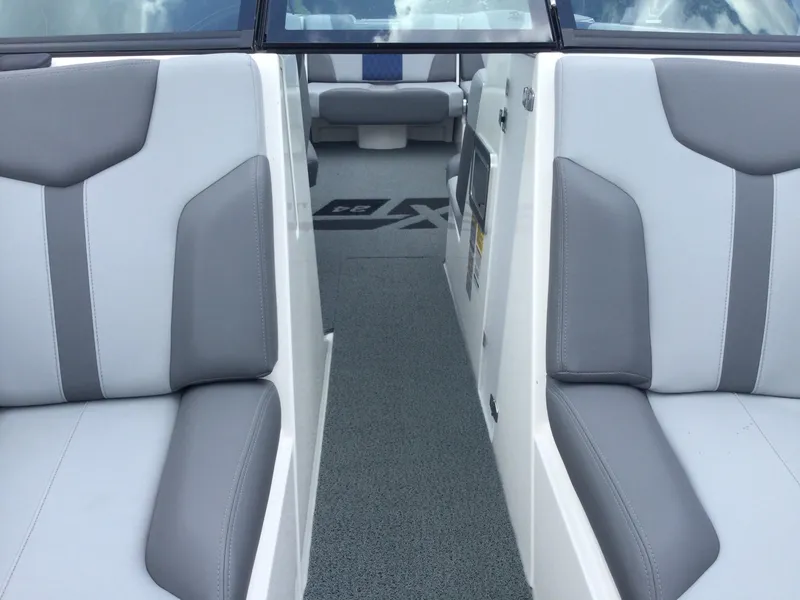 Slide: The Image of 2022 MasterCraft XT24 interior with gray and white seating, showcasing modern design. - 29