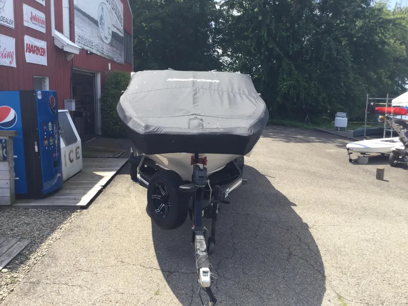 Slide: The Image of 2022 MasterCraft XT24 boat covered and parked outside a dealership. - 3