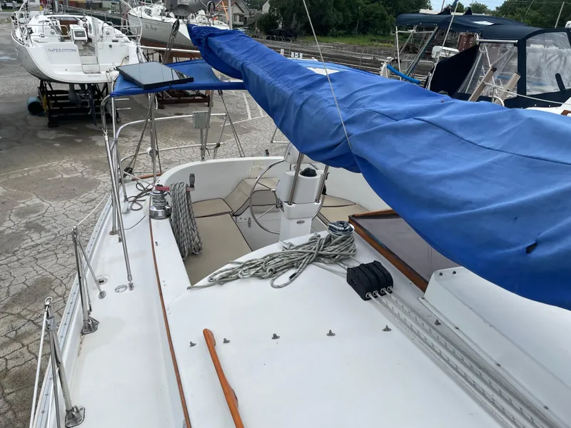 Slide: The Image of 1987 Nonsuch 30 Ultra sailboat with blue sail cover, docked in a marina. - 10