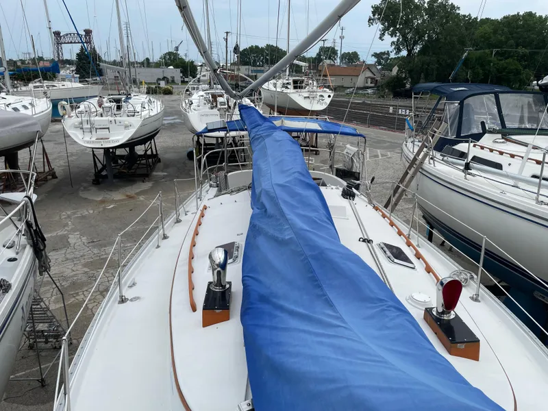 Slide: The Image of 1987 Nonsuch 30 Ultra sailboat in a marina, covered mast, surrounded by other boats. - 11