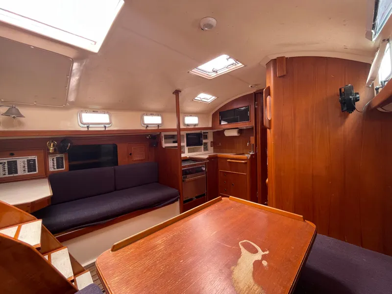 Slide: The Image of Interior of 1987 Nonsuch 30 Ultra sailboat with wood finish and seating area. - 17