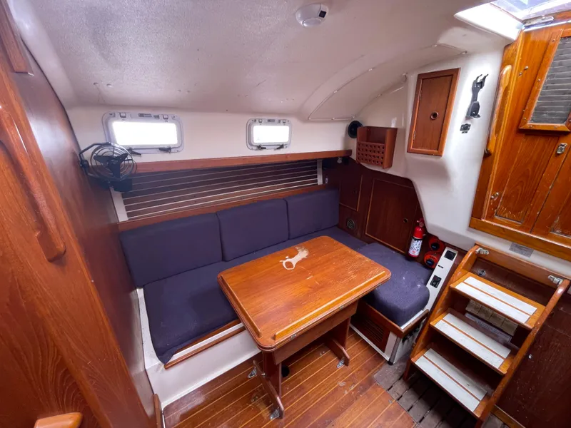 Slide: The Image of Interior of 1987 Nonsuch 30 Ultra sailboat with wooden furnishings and seating area. - 18