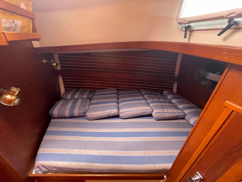 Slide: The Image of Cozy cabin interior of 1987 Nonsuch 30 Ultra sailboat with striped cushions. - 22