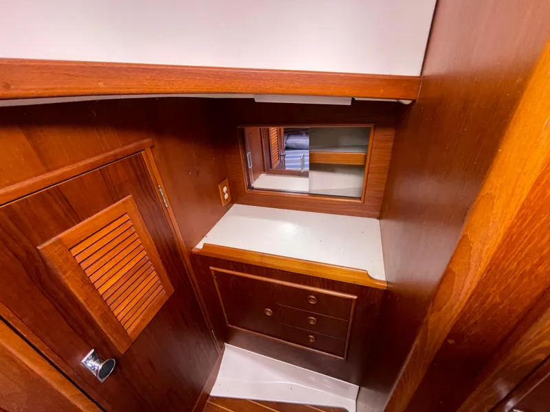 Slide: The Image of Interior of 1987 Nonsuch 30 Ultra sailboat with wooden cabinetry and mirror. - 23