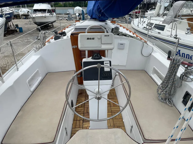 Slide: The Image of 1987 Nonsuch 30 Ultra sailboat cockpit with steering wheel and navigation equipment. - 4