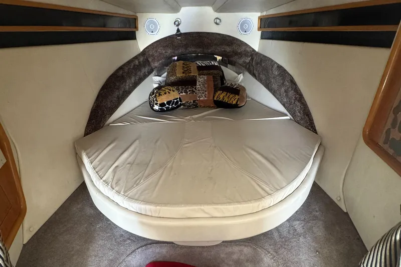 Slide: The Image of Cozy cabin interior of 1999 Black Thunder 430 boat with plush bedding and pillows. - 5