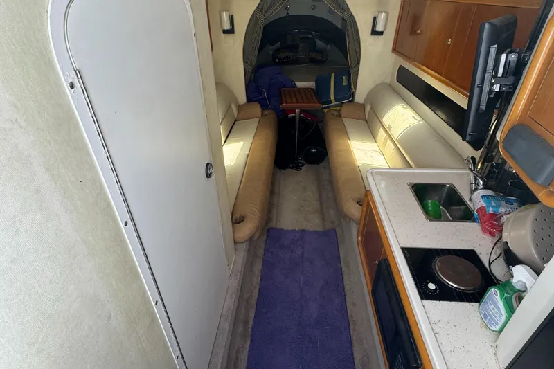 Slide: The Image of Interior of a 1999 Black Thunder 430 boat with kitchenette and seating area. - 7