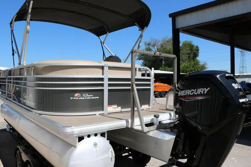 Slide: The Image of 2021 Sun Tracker Party Barge 20 DLX pontoon boat with Mercury 90 engine, docked outdoors. - 10