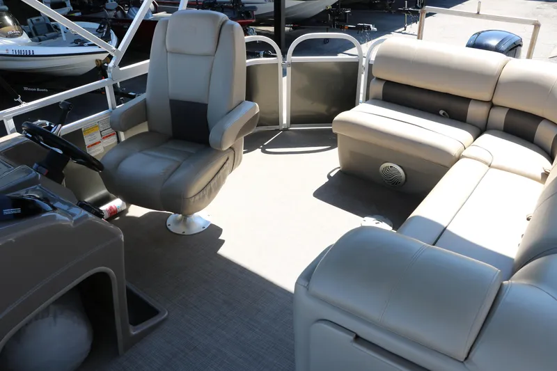Slide: The Image of 2021 Sun Tracker Party Barge 20 DLX interior with seating and steering console. - 13