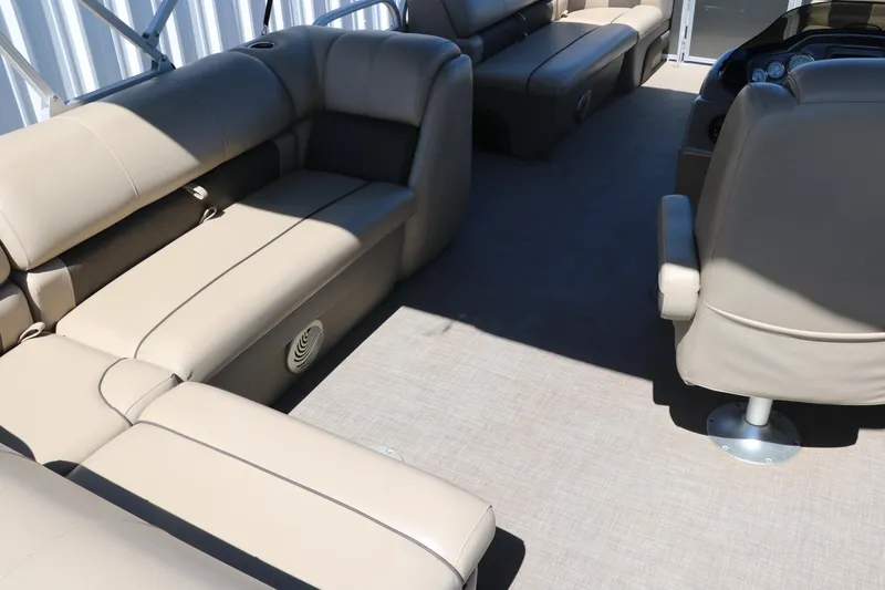 Slide: The Image of 2021 Sun Tracker Party Barge 20 DLX interior with beige seating and spacious layout. - 17