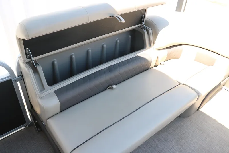 Slide: The Image of 2021 Sun Tracker Party Barge 20 DLX storage compartment with open seat cushion. - 23