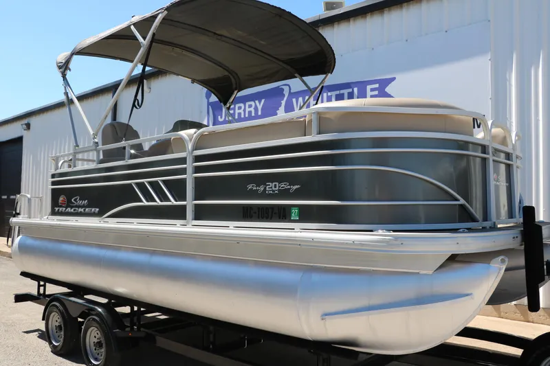 Slide: The Image of 2021 Sun Tracker Party Barge 20 DLX pontoon boat on trailer, parked outdoors. - 3