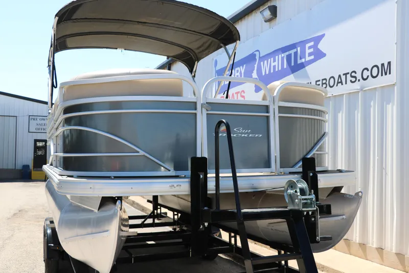 Slide: The Image of 2021 Sun Tracker Party Barge 20 DLX pontoon boat on trailer, parked outside dealership. - 5