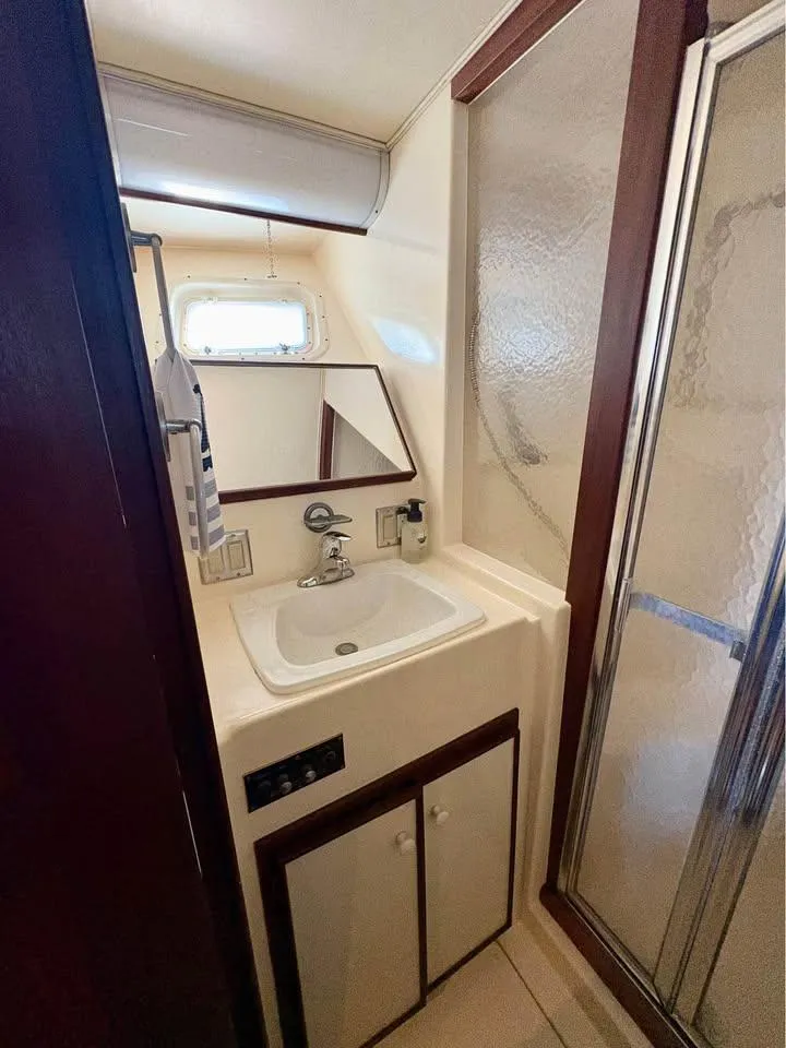 Slide: The Image of Bathroom interior of 1983 Hatteras 46 Convertible yacht with sink and shower. - 12