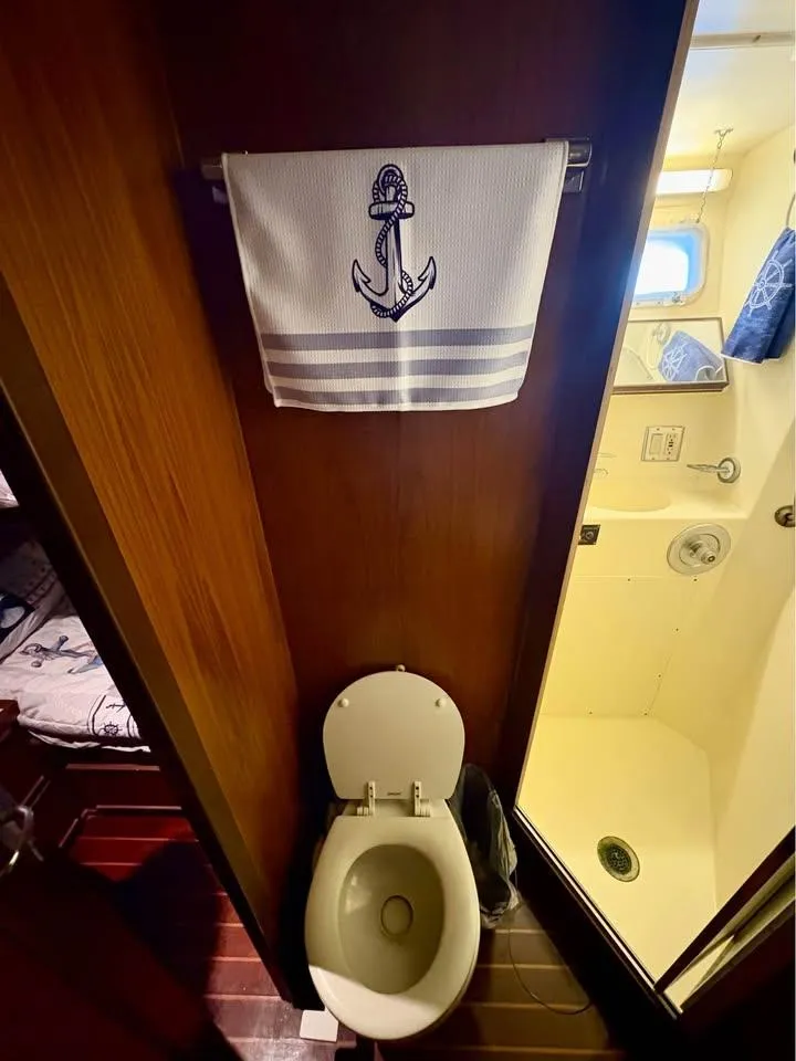 Slide: The Image of Bathroom in 1983 Hatteras 46 Convertible yacht with nautical-themed towel. - 13