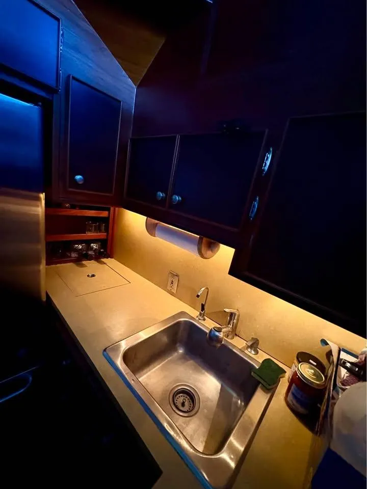 Slide: The Image of Galley kitchen in 1983 Hatteras 46 Convertible yacht with stainless steel sink and wooden cabinets. - 9