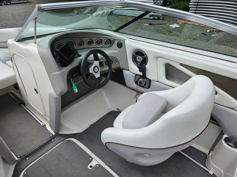 Slide: The Image of 2008 Bryant 233 boat interior with steering wheel and dashboard controls. - 11