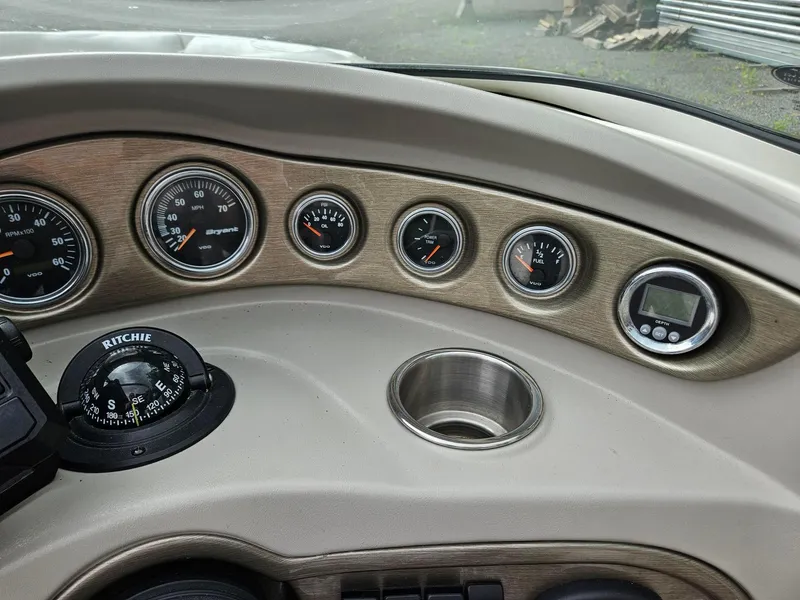 Slide: The Image of Dashboard of a 2008 Bryant 233 boat with gauges and compass. - 14
