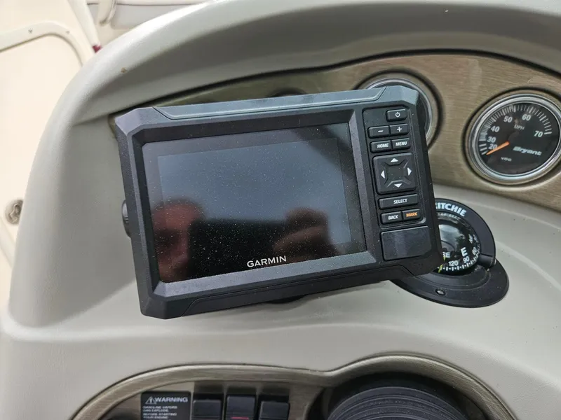 Slide: The Image of Garmin GPS device on 2008 Bryant 233 boat dashboard with speedometer and compass. - 15