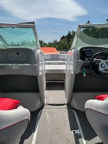 Slide: The Image of Interior view of a 2008 Bryant 233 boat with red cushions and steering wheel. - 16