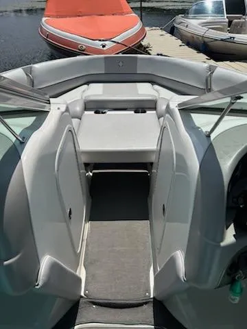 Slide: The Image of 2008 Bryant 233 boat interior with seating, docked near other boats. - 22