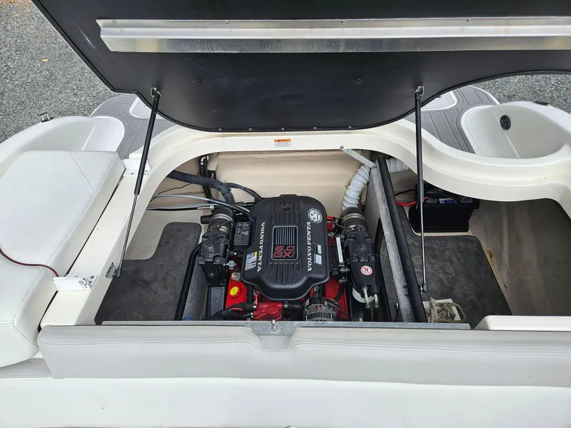 Slide: The Image of Open engine compartment of a 2008 Bryant 233 boat, featuring a Volvo Penta engine. - 29