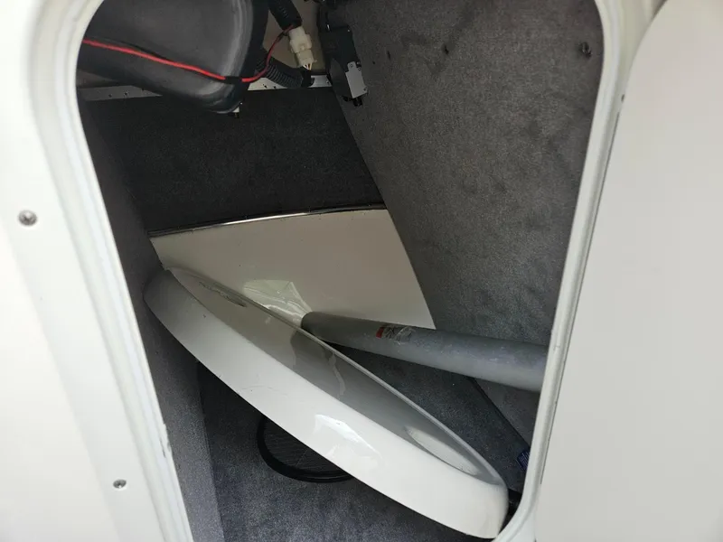 Slide: The Image of Storage compartment of a 2008 Bryant 233 boat with equipment inside. - 30