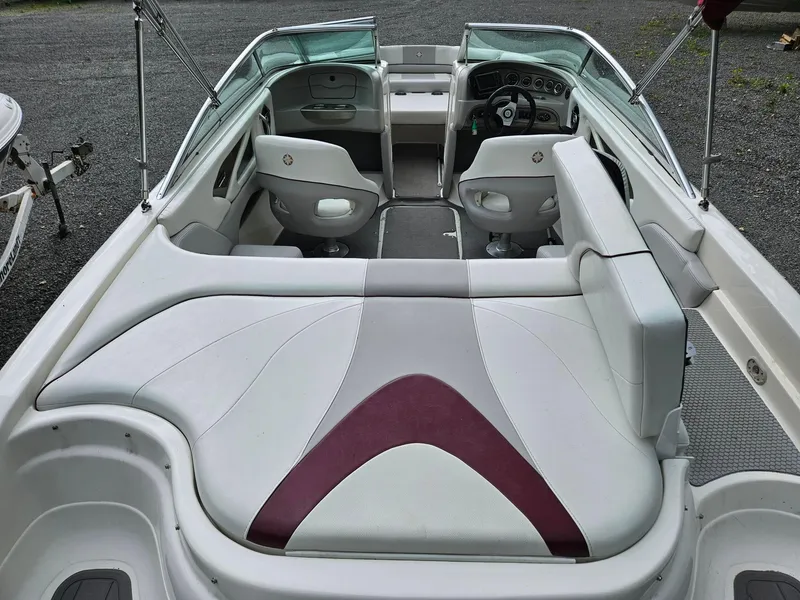 Slide: The Image of Interior of a 2008 Bryant 233 boat with white and maroon seating. - 6
