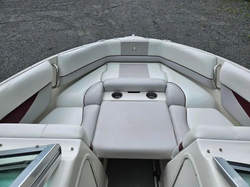 Slide: The Image of 2008 Bryant 233 boat interior with white seating and cup holders. - 7