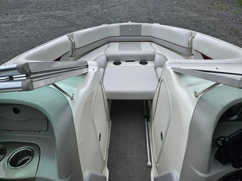 Slide: The Image of 2008 Bryant 233 boat interior with white seating and cup holders. - 8