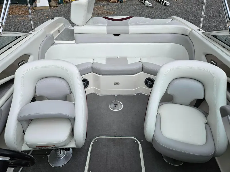 Slide: The Image of Interior of a 2008 Bryant 233 boat with white and gray seating. - 9