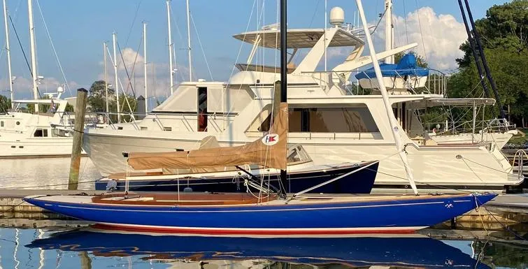The Image of 2023 C.W. Hood 32 Daysailer docked, featuring sleek blue hull and tan sail cover. - 0