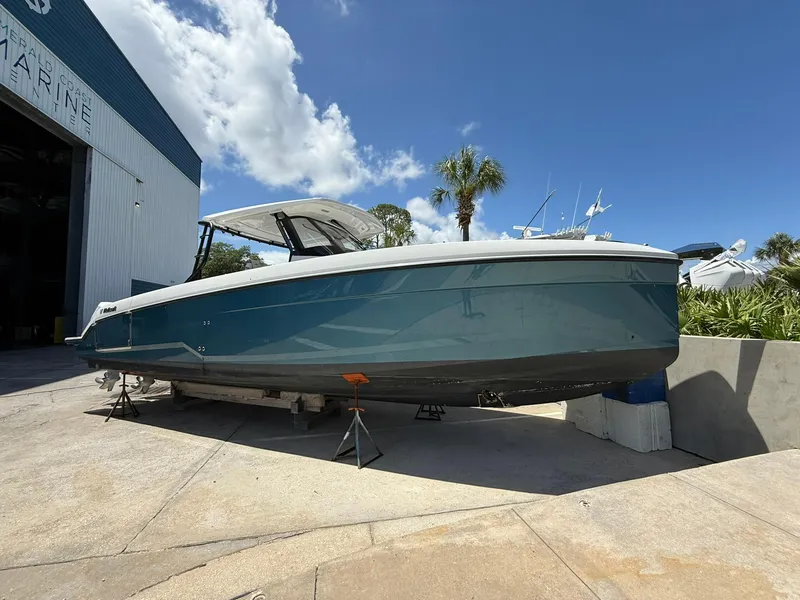 The Image of 2025 Wellcraft 38 T-Top boat on dry dock under a clear blue sky. - 0